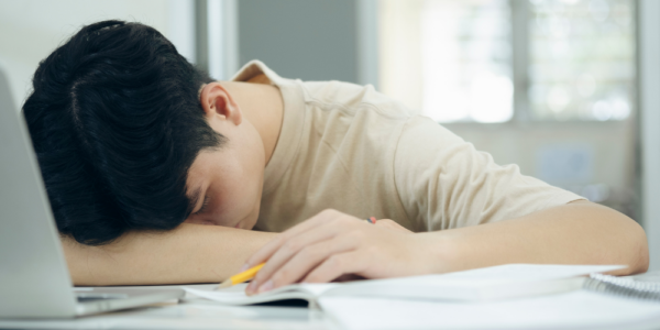 student sleeping on desk 
