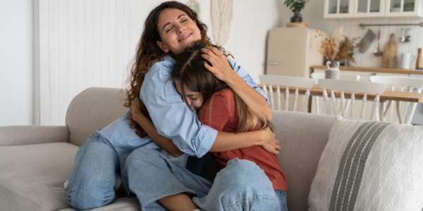 mom and daughter hugging